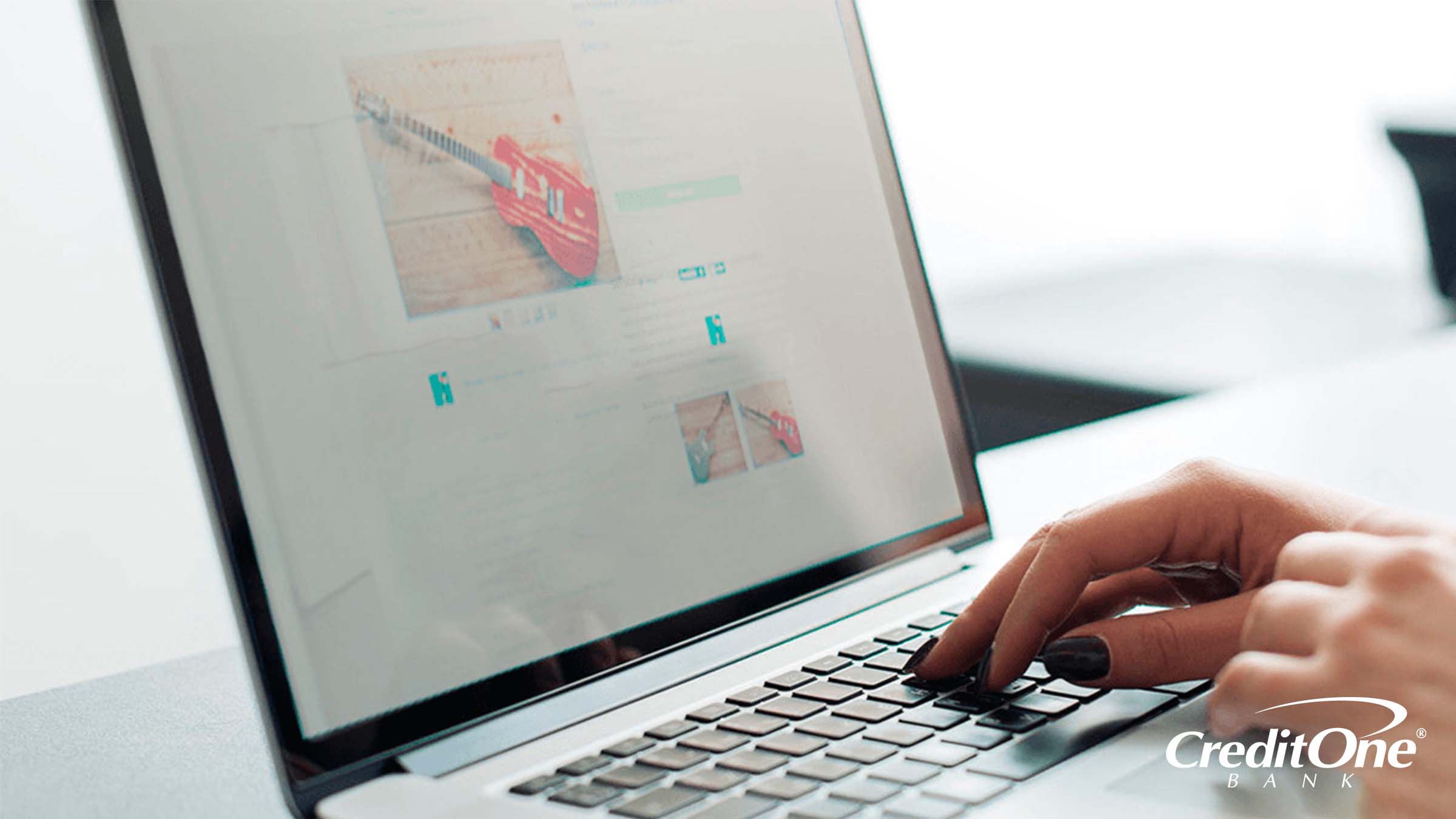 A woman’s hands rest over a laptop’s keyboard while shopping for a guitar online. Perhaps she’s checking if this is a secure website, as a way to protect against identity theft.